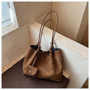 Detail of vintage matte brown tote bag with decorative knotted shoulder strap and matching pouch