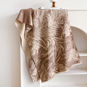 Macro detail of Chinese style cashmere-like scarf with mountain and phoenix jacquard pattern
