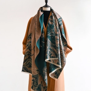 Detailed view of the double-sided jacquard scarf showing landscape pattern and long tassels