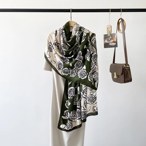 Detail of elegant retro rose print silk scarf styled over a minimalist white dress