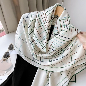 Detailed view of the luxury herringbone silk scarf with hand-rolled edges and grid pattern