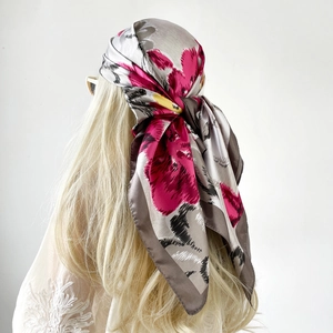 Detail of printed satin headscarf with pink floral pattern and silk-like texture