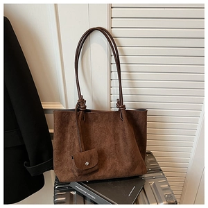 Detail view of large brown suede tote bag with detachable small pouch and long strap