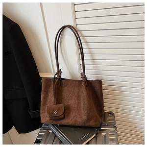 Detail of vintage brown frosted tote bag with knot straps and small coin purse attached