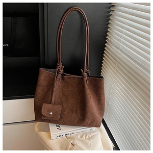 Detail of vintage brown suede tote bag with long straps and mini coin purse attachment