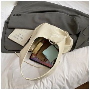 Interior view of large cream tote bag showing capacity for tablet, phone and cosmetics