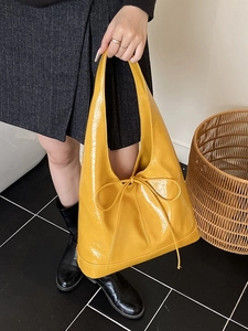 Glossy yellow large hobo tote bag with delicate bow and seamless wide handle design