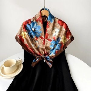 Detailed close-up of a 90cm satin square scarf with vintage floral print on a wood pattern