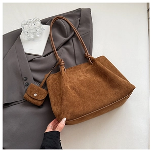 Detail of vintage matte brown tote bag with suede texture and knotted handle detail