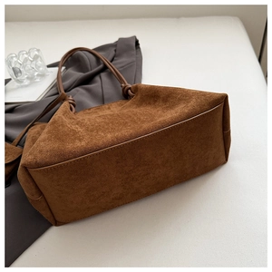 Detailed close-up of retro matte brown tote bag with elegant knot handle detail