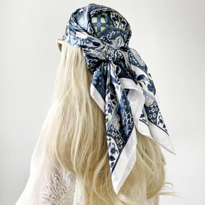Detail of silk satin headscarf with blue baroque floral pattern and geometric motifs