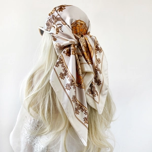 Baroque floral satin silk scarf with gold paisley patterns worn as an elegant headwrap