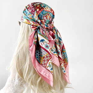 Detailed view of bohemian floral print satin square scarf worn as a headscarf