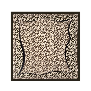 Detailed close-up of a square satin scarf with leopard floral print and dark brown border