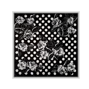 Detailed flat lay of black satin scarf with white polka dots and camellia line art