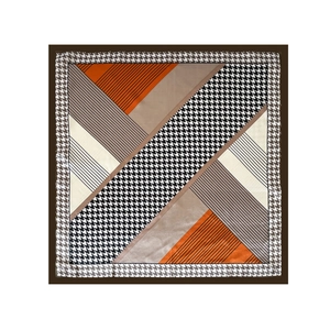 Detail of printed satin square scarf with geometric patchwork and houndstooth pattern