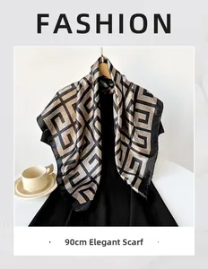 Elegant 90cm square scarf with gold geometric patterns on a black silk dress