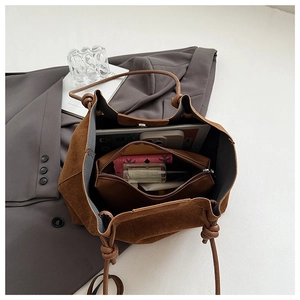 Top view of large capacity matte brown bucket bag showing the spacious interior and pouch
