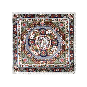 Flat lay of vintage square silk scarf with traditional floral and pavilion patterns