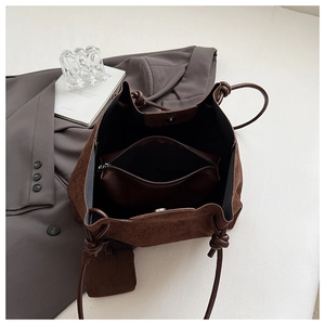 Detail of interior storage featuring a zipper pouch and magnetic snap of the tote bag