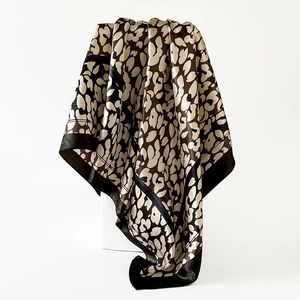 Detail of high-gloss leopard print satin square scarf with elegant black border trim