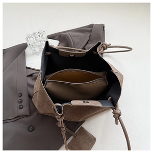Macro view of the spacious interior with magnetic closure and brown matte suede texture
