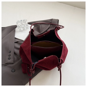 Detail of burgundy matte tote interior showing zipper compartment and magnetic snap closure