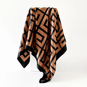 Detail view of large square satin scarf featuring geometric patterns and glossy finish