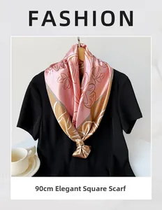 Elegant 90cm pink square satin scarf featuring floral patterns tied on a black shirt style