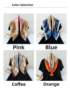 Detail view of large square satin scarves in pink, blue, coffee, and orange floral prints