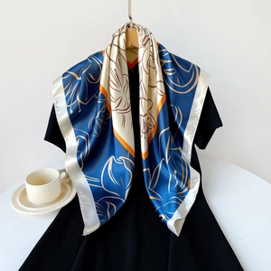 Detail view of 90cm satin scarf with blue flower pattern on a wooden hanger