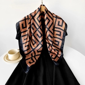 Detail of satin square scarf featuring bronze and black geometric Greek key pattern