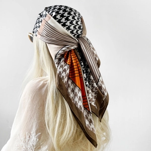 90cm satin square scarf with orange geometric blocks and houndstooth pattern as a headwrap