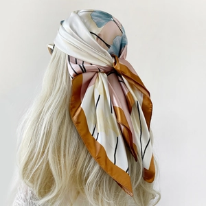 Detailed back view of a satin square scarf with floral print worn as a headwrap