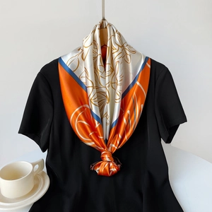 Floral print satin silk scarf styled on a black shirt with elegant flower patterns