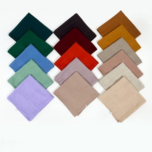 Matrix display of fifteen colorful square scarves with lightweight texture and fine stitching
