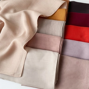 Detail showing the fine machine-stitched edges and lightweight texture of colorful hijabs