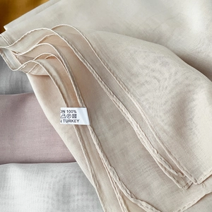 Macro detail of Turkish scarf fabric showing fine texture and precision stitched edges