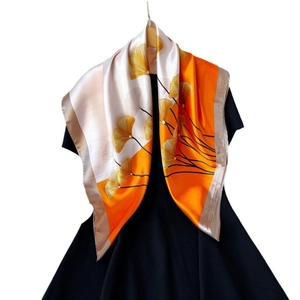 90cm satin square scarf featuring orange and cream patchwork with golden ginkgo leaf prints