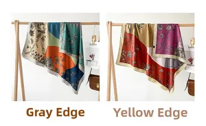 Detail of floral printed silk square scarves in green and red patterns on a wooden hanger