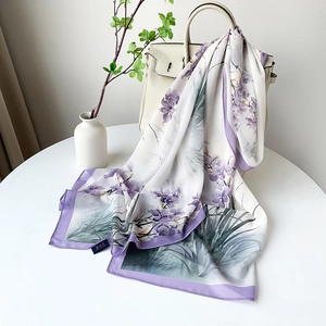 Détail d'une écharpe en satin léger avec imprimé floral violet et finition de l'ourlet
