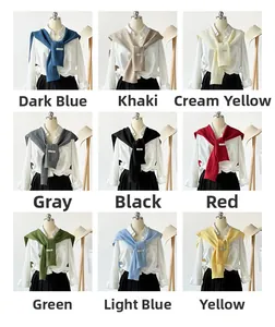 Detail of knitted cutout shawls in nine colors including khaki, red, and blue shades