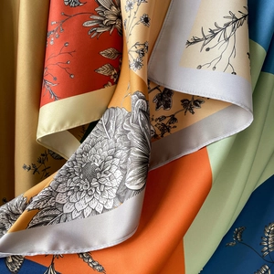 Detail of premium 90cm silk scarf showing intricate floral prints and vibrant patchwork fabric