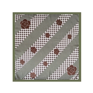 Detailed pattern of houndstooth checks and camellia flowers on olive green silk scarf