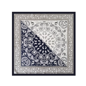Detailed flat lay of navy and white paisley floral print satin square silk scarf