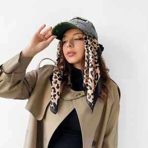 Detailed view of dark green baseball cap with leopard silk scarf and Jamaica embroidery