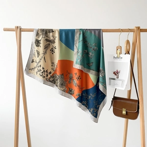 Detailed view of 90cm two-tone silk scarf with vintage floral prints on a wooden hanger