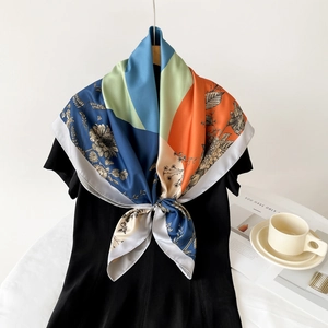 Elegant silk scarf tied on neck featuring floral patterns and color-block design