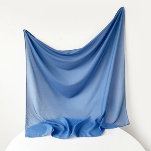Detail view of sky blue Muslim hijab fabric with soft pleated texture and smooth edges