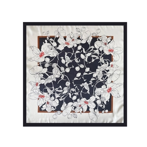Detailed view of floral pattern on 90cm navy blue satin silk square scarf with borders